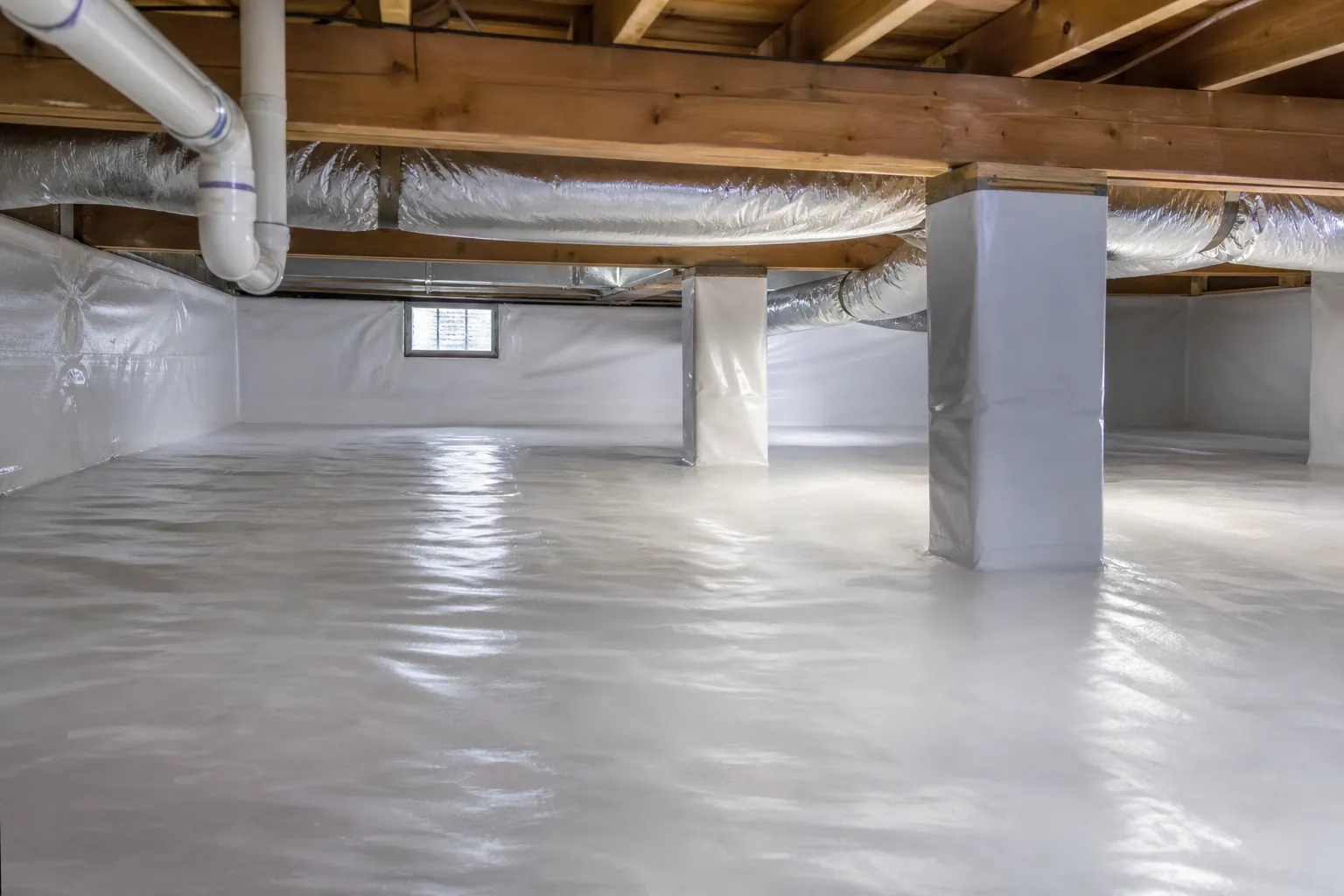 Encapsulated crawl space with white vapor barrier, wrapped support piers, exposed joists, ducts, and plumbing.