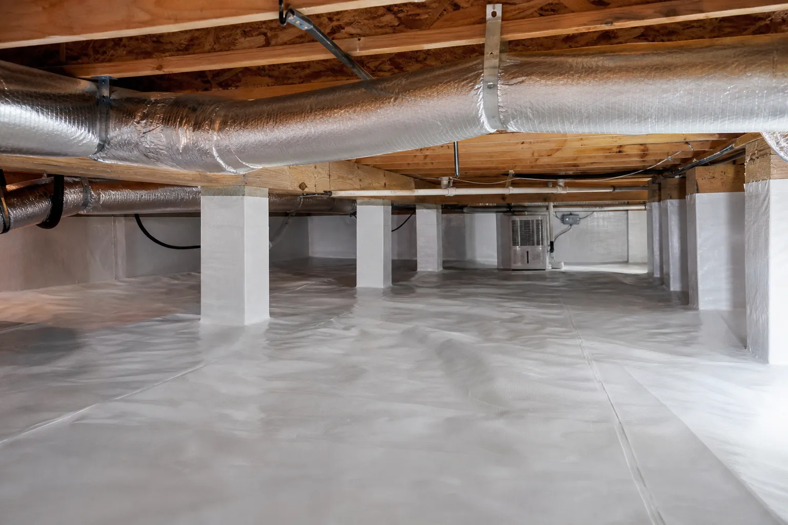 Encapsulated crawl space with white vapor barrier, wrapped ductwork, wood joists, and masonry support piers.