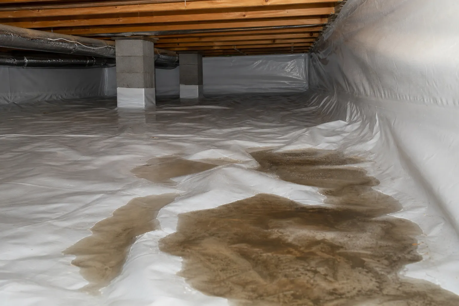 Editorial illustration of Do Wrinkles in a Crawl Space Liner Cause Water to Puddle? in North Carolina
