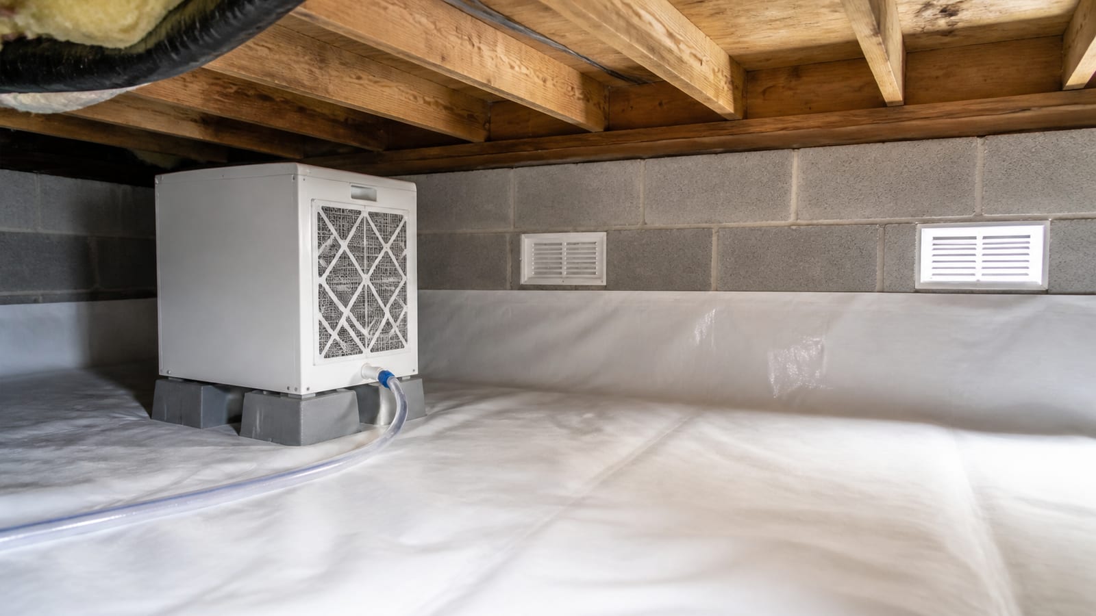 Crawl space dehumidifier installation inside a sealed Fuquay-Varina crawl space